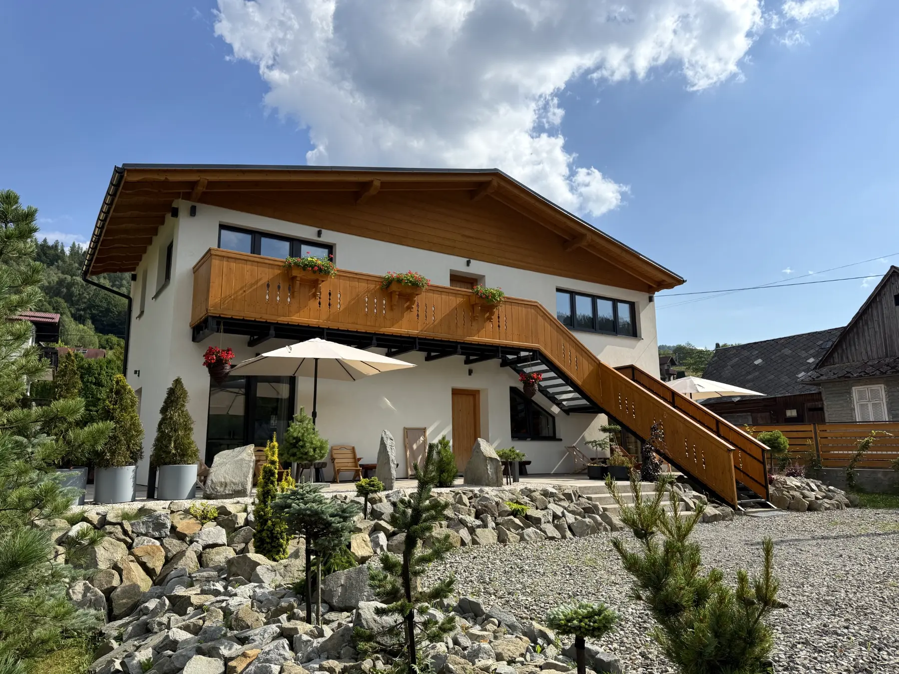 Górski ogród z kamieniem przed apartamentami w Szczyrku